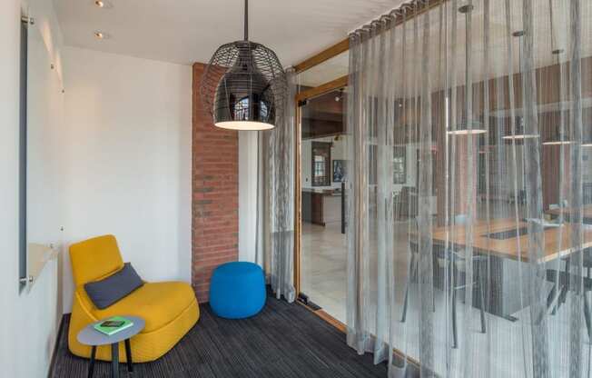 a lounge area with chairs and a glass door