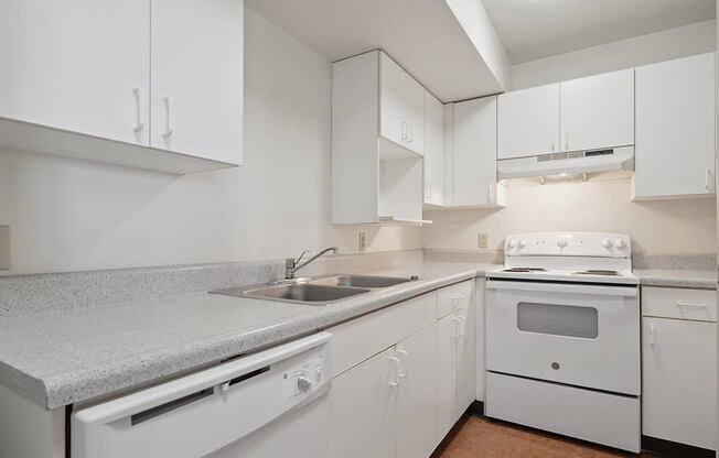 a kitchen with white appliances and white cabinets