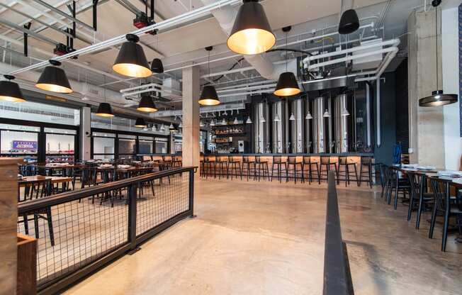 the interior of a restaurant with tables and chairs and a fence