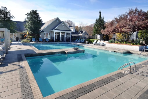 a large swimming pool with a house in the background at Willowest in Collier Hills, Atlanta, Georgia