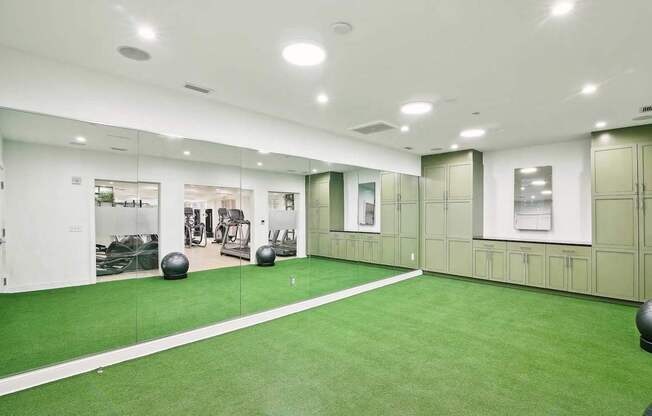 A gym with green flooring and white walls.