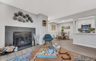 a living room with a fireplace and a dining room in the background at Brampton Moors, Cary
