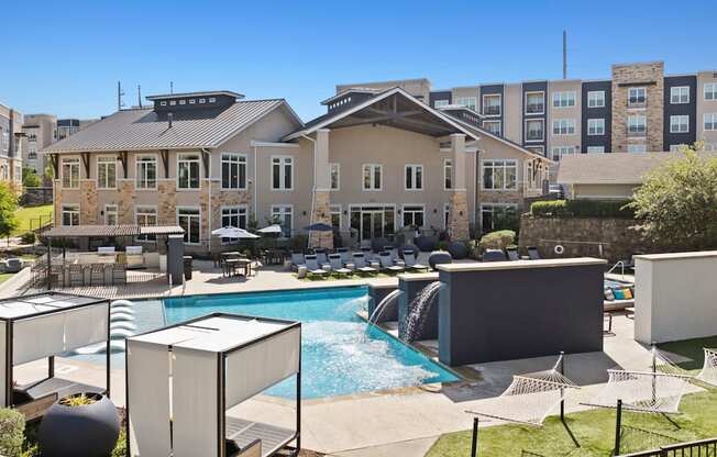 A large building with a pool in front of it.