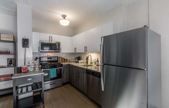 The Edison apartments kitchen with stainless appliances and white cabinetry