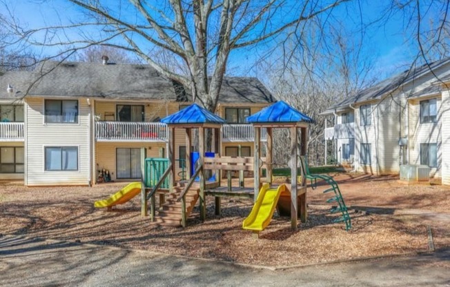 a playground in a yard in front of a house