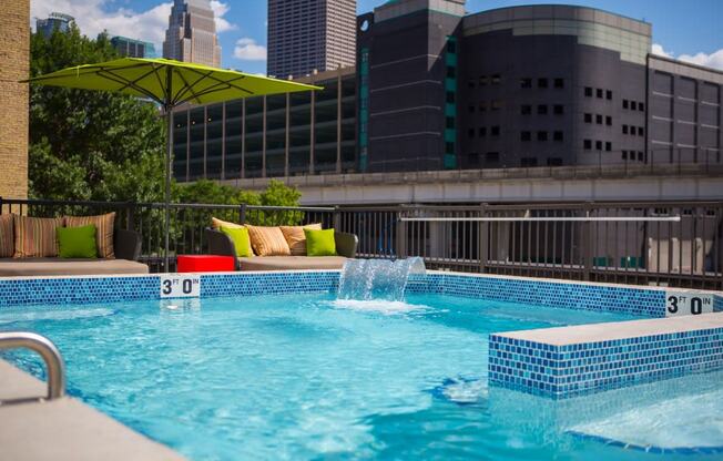 Sparkling rooftop pool with water feature