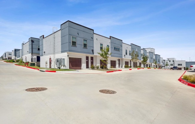a street view of a row of new apartment buildings