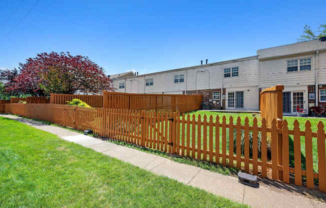 a wooden fence in front of a house