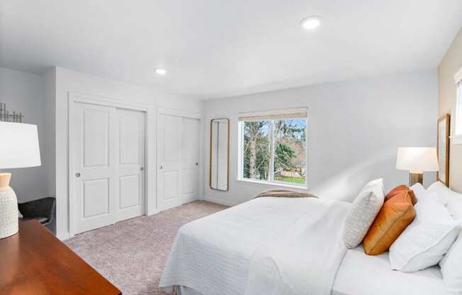 a bedroom with a bed and a window
