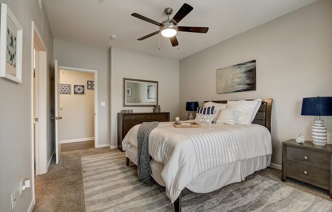 a bedroom with a bed and a ceiling fan