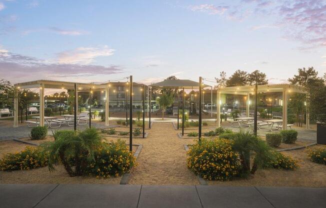 a park with glass pavilions in the evening