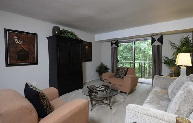 Large living room with private balcony at Liberty Gardens Apartments, Baltimore, MD 21244