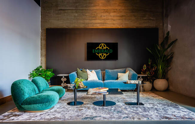 a living room with a blue couch and two turquoise chairs
