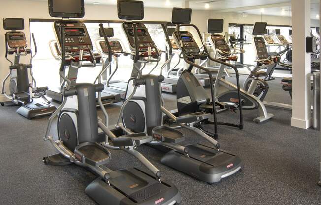 a group of exercise machines in a gym