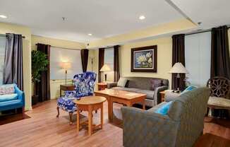 a living room with a couch and chairs and a table