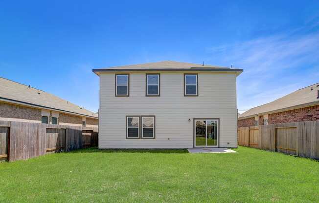 a white house with a yard in front of it