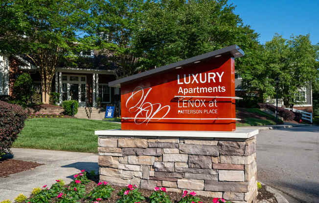 a sign for luxury apartments in front of a building