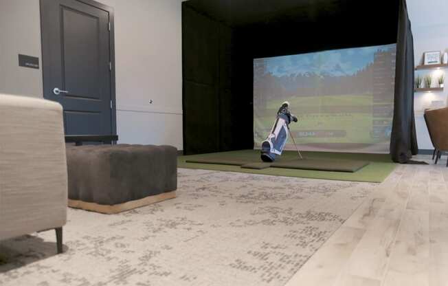 Golf simulator Park125 West Dodge in Omaha, NE a man plays golf on a large screen tv in a living room