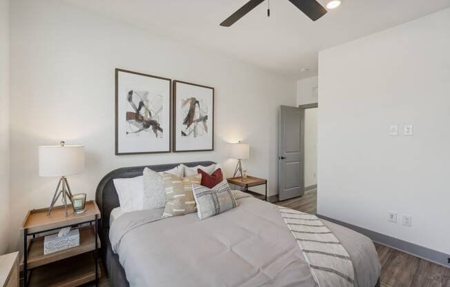 a bedroom with a large bed and a ceiling fan at Meridian at CityPlace, Woodbury, MN
