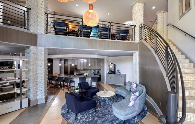 a living room and dining room with a spiral staircase at The Tribute, Raleigh, NC, 27612