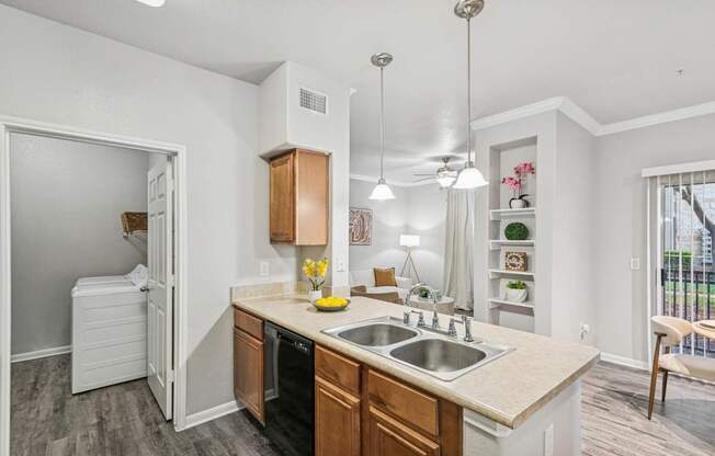 A kitchen with a sink, stove, and refrigerator.