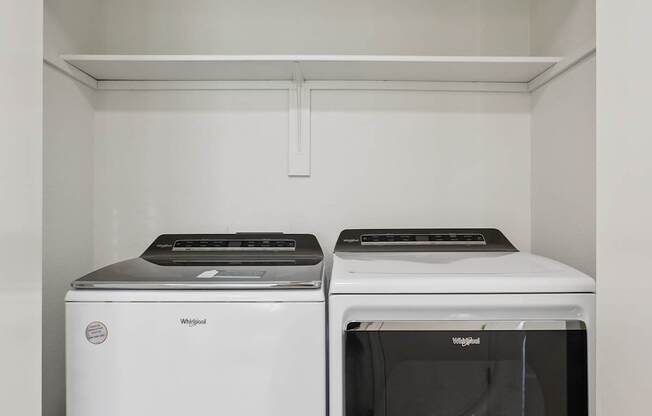 A white dishwasher and oven in a kitchen.