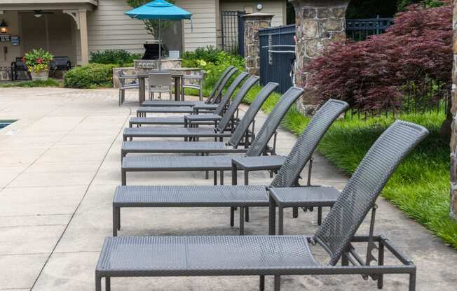 a row of chairs and tables outside of a patio