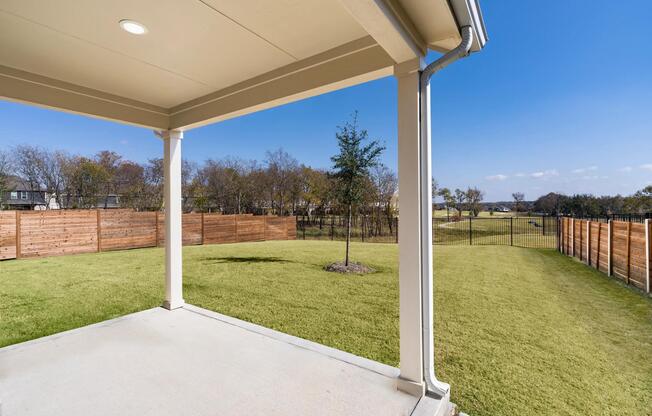 A covered patio opens to a fenced backyard, offering a private outdoor space suited for everyday moments and time spent at home.