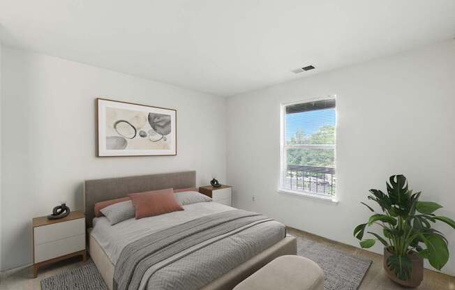 A bedroom with a bed, nightstand, and a plant.
