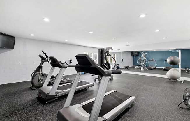 A gym with treadmills and exercise equipment.