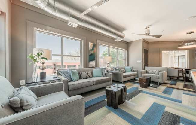 a living room filled with furniture and a large window