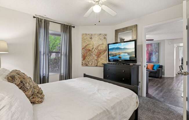 A bedroom with a large bed and a television.