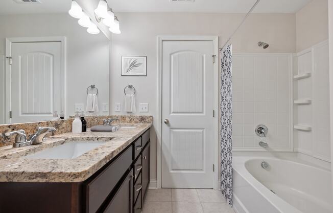 Harris Trail Luxury Townhomes for rent Richmond Hill, GA photo of a bathroom with a sink and a shower and a bath tub