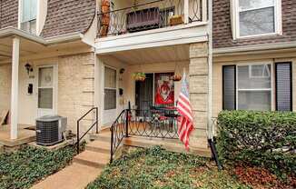 Exterior image of building with stairs and flag