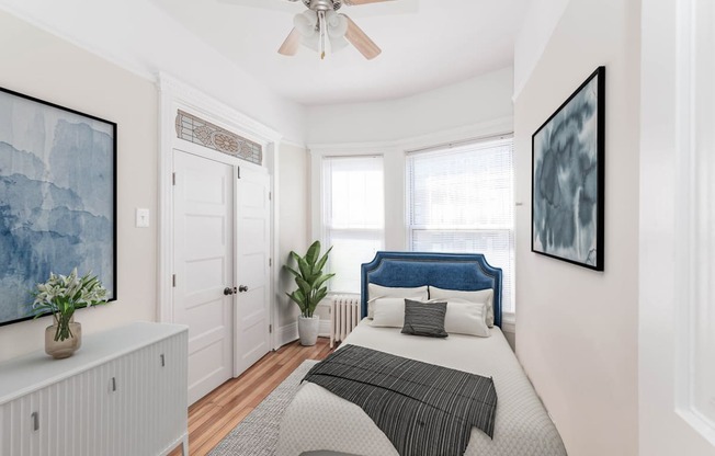 a bedroom with a bed and a ceiling fan