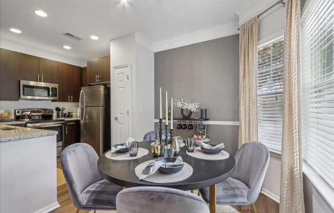 a kitchen and dining room with a table and chairs