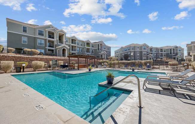 our apartments offer a swimming pool with an apartment building in the background