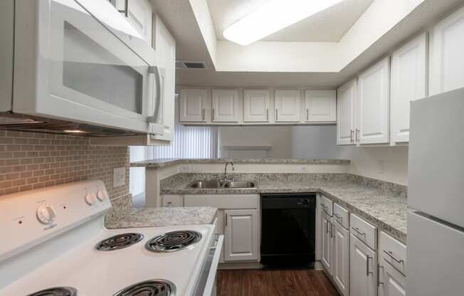 This is a photo of the kitchen in a 717 square foot 1 bedroom, 1 bath apartment at Canyon Creek Apartments in Dallas, TX