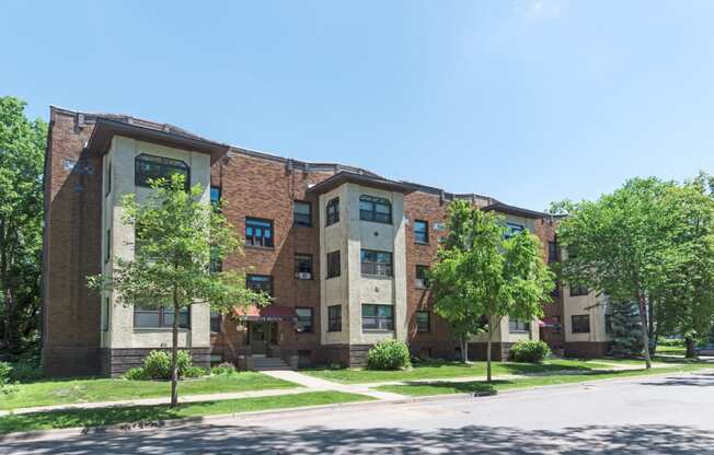 a large brick building with trees in front of it