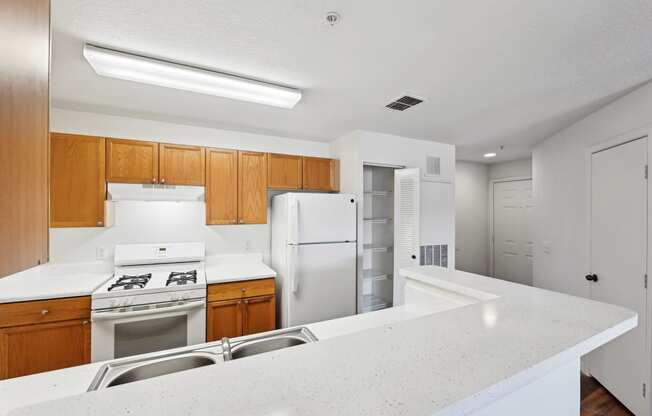 the preserve at ballantyne commons apartment kitchen with white appliances and wood cabinets