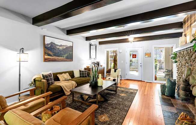 Sitting room with chairs, fireplace and wooden beams