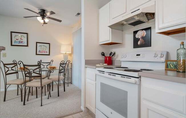 A kitchen with white appliances and a fan.at Camden Place, Dublin, OH 43016