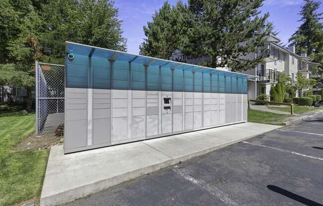 outdoor package locker station with trees in the background at Casa Blanca Apartment Homes, Everett