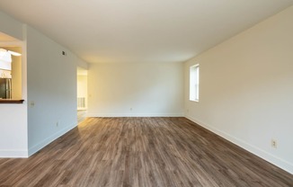 a bedroom with hardwood floors and white walls  at Charlesgate Apartments, Towson