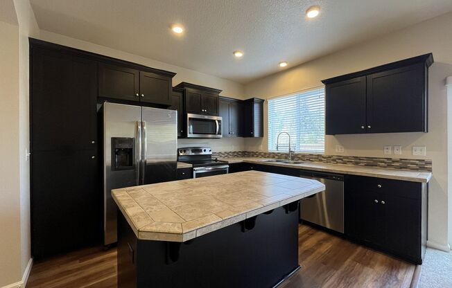 Stylish 3-Bedroom Bethany Residence with Open-Concept Living, Fenced Yard, and Attached Garage