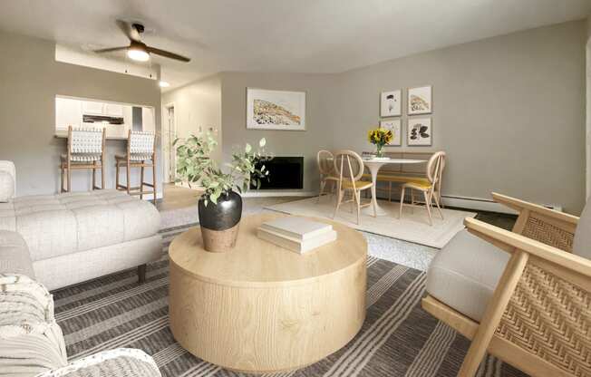 A living room with a round wooden coffee table in the center.