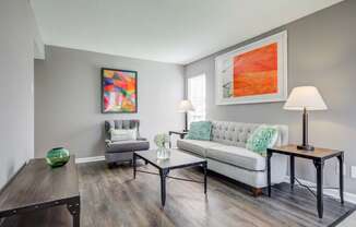 Westchase Apartments in Harvey LA photo of a living room with a couch and a table and hardwood floors