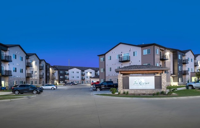 The entrance to a residential complex called The Grove is shown at dusk.