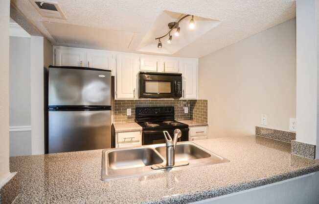 a kitchen with stainless steel appliances and granite counter tops