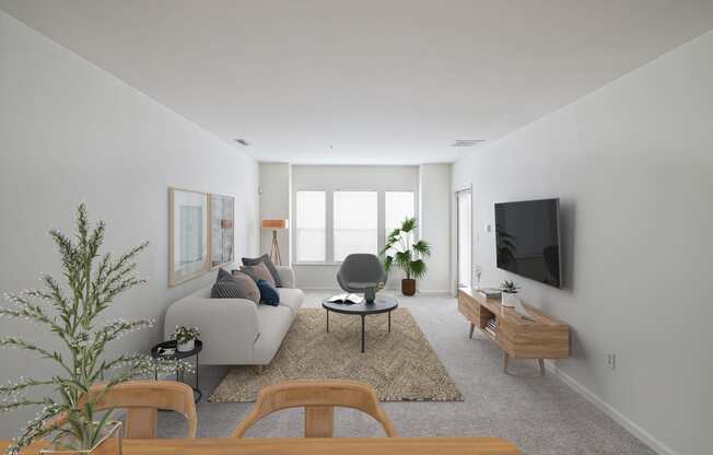 a living room with a white couch and a television
